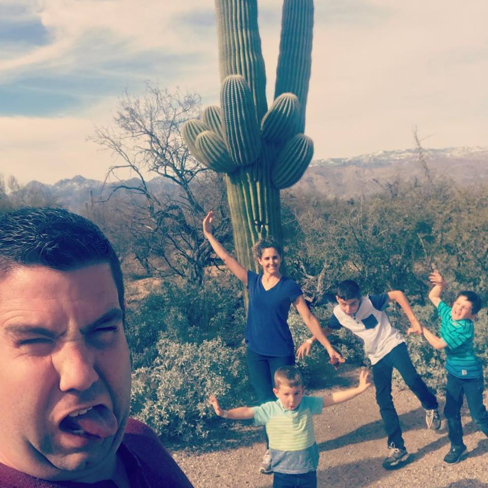 silly face picture in front of a saguaro cactus