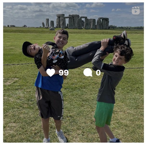 Kids posing like the stones at Stonehenge