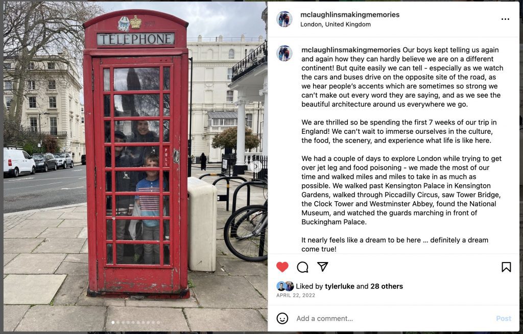 Visiting London and taking a picture in a telephone booth