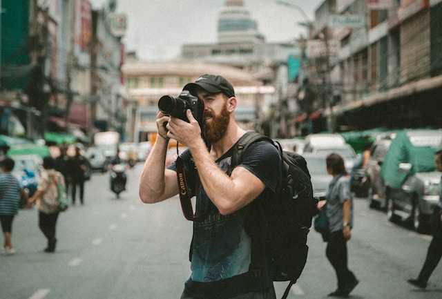 Photographer takes a photo in a busy city