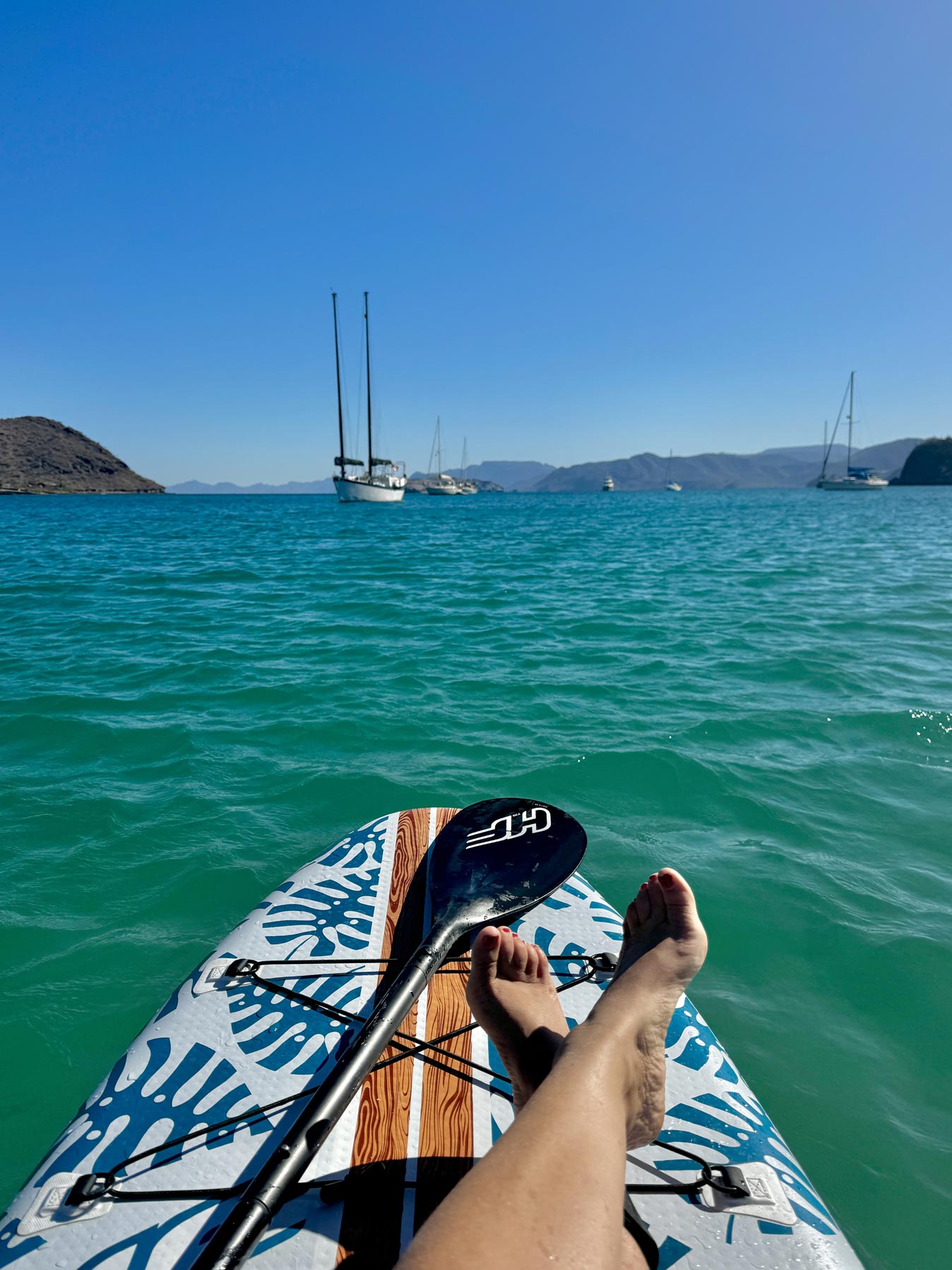 paddleboarding in the calm water at Playa Santispac