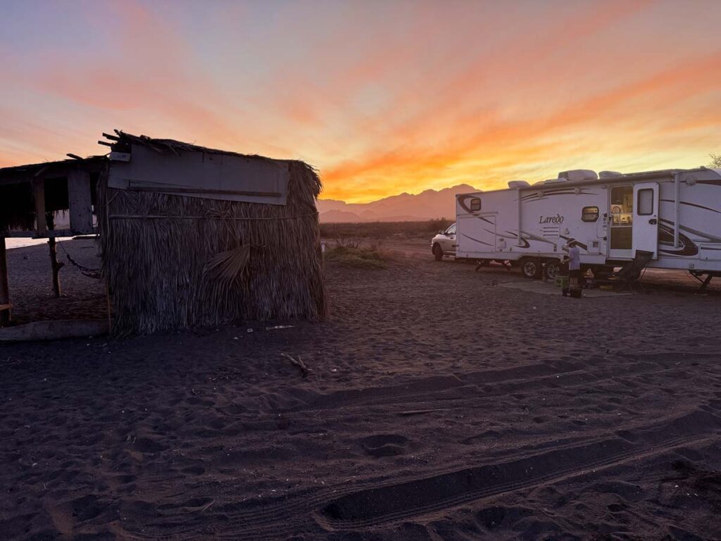 Palapas and Sunset at this free camping beach near Loreto