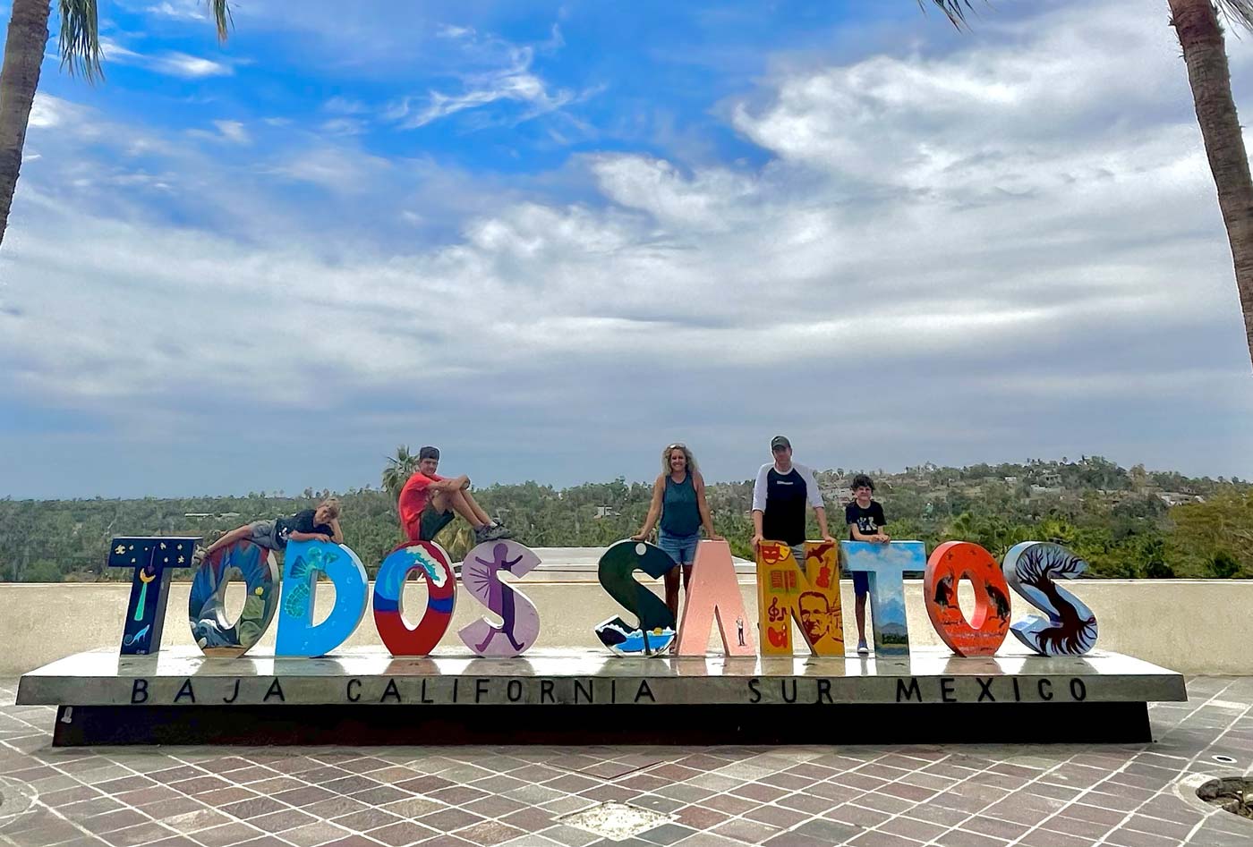 PIcture with our kids at the Todos Santos sign in 2023