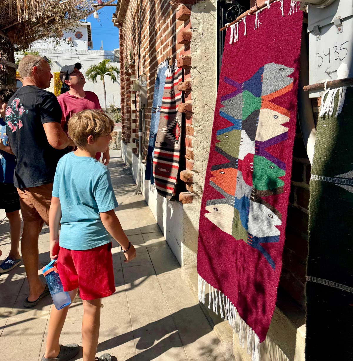 exploring locally made blankets in Todos Santos with our kids