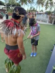 Learning to weave banana leaves at the Chief's Luau